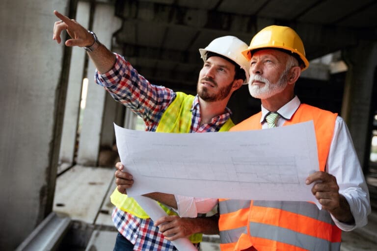 Architect and construction engineer or surveyor discussion plans and blueprints